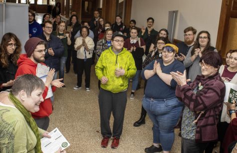 A crowd of around 40 people, students and faculty, showed up in support of the EIUs chapter of University Professionals of Illinois at Old Main as they delivered signed postcards to the administration supporting salary raises Monday afternoon.