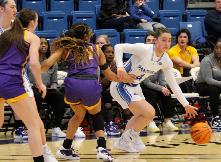 Lyric Johnson, a freshman guard, dribbles past defenders during the womens Senior Day basketball game against the Tennessee Tech Golden Eagles at Lantz Arena Saturday afternoon. Johnson scored seven points and had three steals.