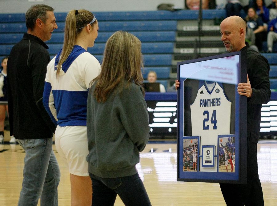 Head Coach Matt Bollant hands Morgan Litwiller, a senior forward, a framed jersey before the start of the womens Senior Day basketball game against the Tennessee Tech Golden Eagles at Lantz Arena Saturday afternoon.