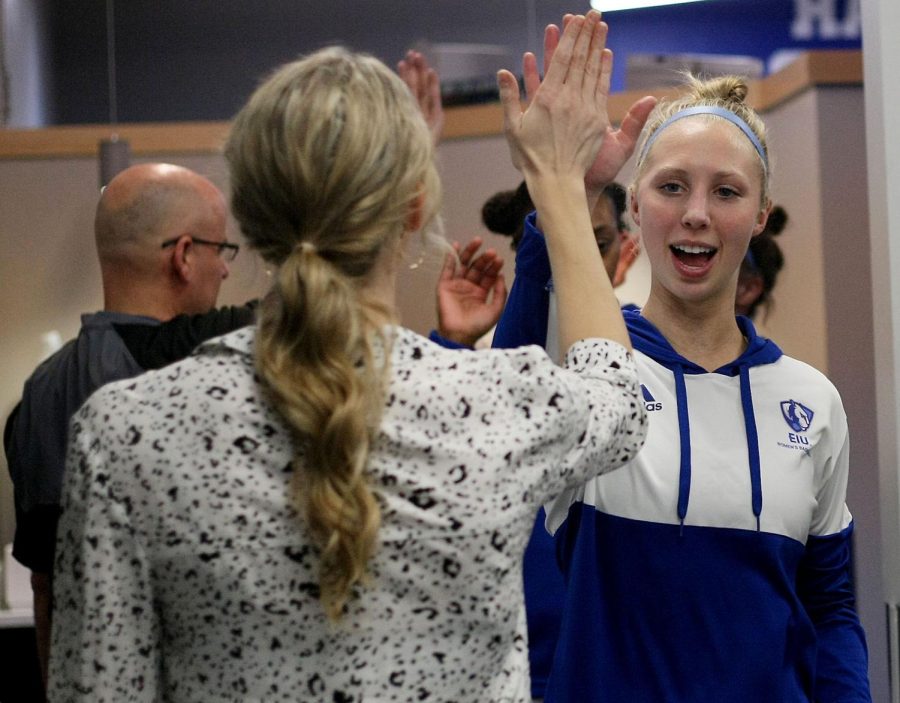 Julia Bengtson (20), a sophomore guard, high fives Assistant Coach Allie LeClaire before playing in the womens basketball game against the Morehead State Eagles at Lantz Arena Wednesday afternoon. The Panthers won 60-49. This victory helped secure the Panthers the second seed slot in the Ohio Valley Conference Tournament.