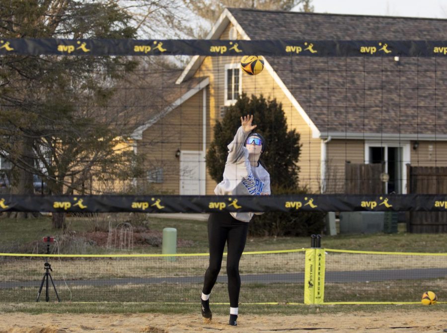 Kate Dean (12), serves the ball over the net to the opponets side during beach volleyball practice on Friday afternoon at Sister City Park.