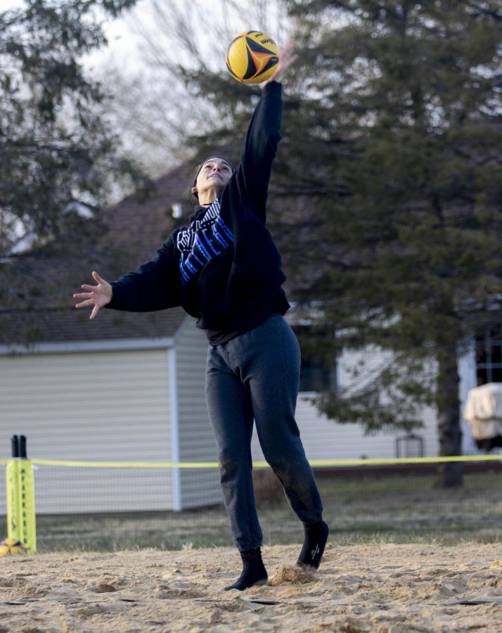 At the beach volleyball practice, Lilli Amettis (14), serves the ball during practice at Sister City Park Friday afternoon.