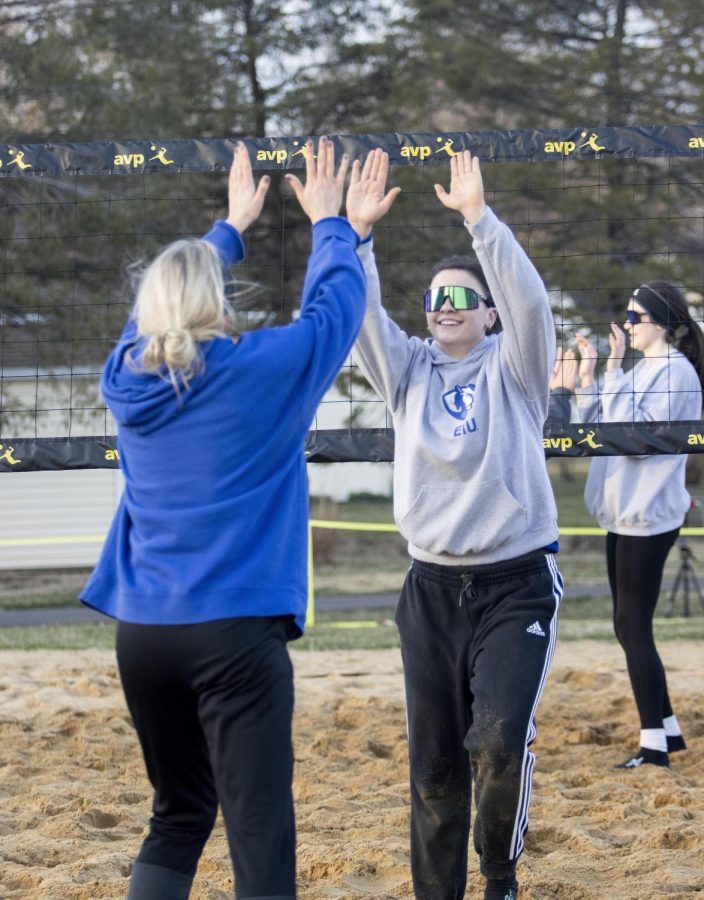Sylvia Hasz and Kaitlynn Flynn high five each other after earning points in their practice match on Friday afternoon at Sister City Park.