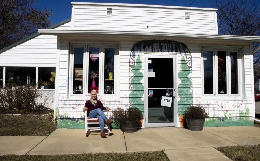 Lynn McGrath poses in front of her flower shop called Bells Flower Corner on Monday afternoon. Her shop sells a variety of different things inside besides flowers such as teddy bears, cards, jewelry, clothing, chocolate, and more.