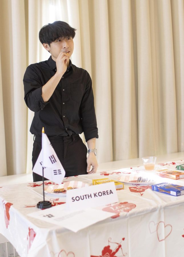 Yoonjin Kim, a marketing major, tastes chocolate from his own country, South Korea, at the chocolate around the world event in the University Ballroom of Martin Luther King Jr. University Union. Kims favorite chocolate are the Italian Ferrero Rochers.