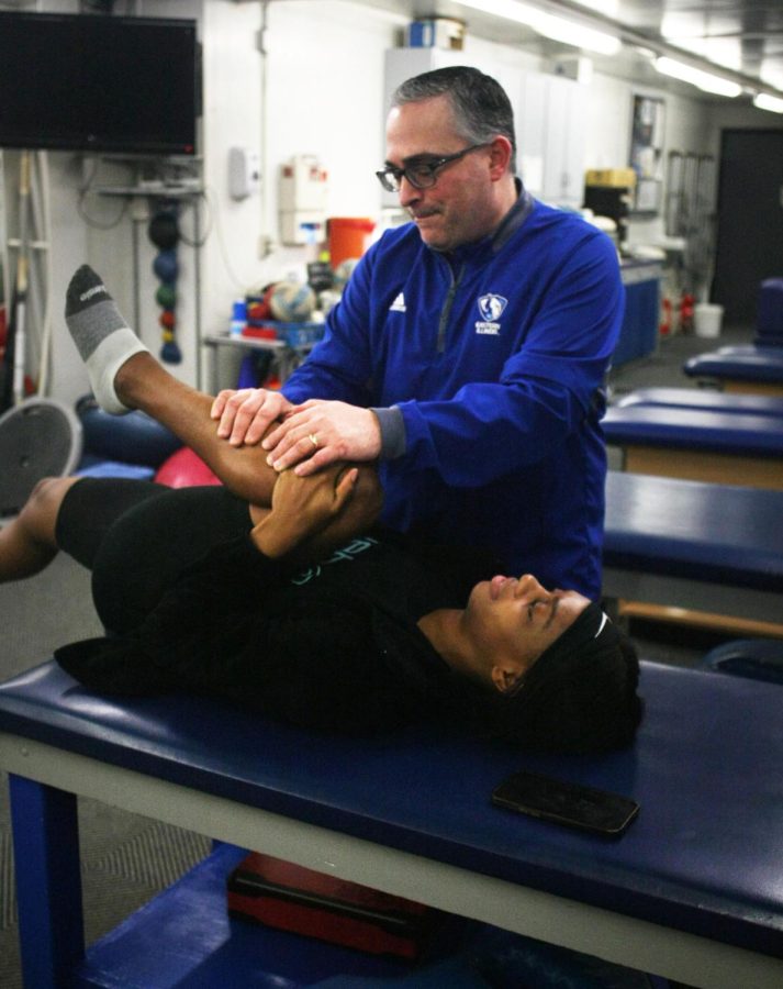 Head Athletic Trainer James Nave helps Eastern track sprints runner Taylor Wright, figure out why her quads are sore. Naves adds pressure to her knee to try to find out where the soreness is coming from on Thursday afternoon in the athletics training room.