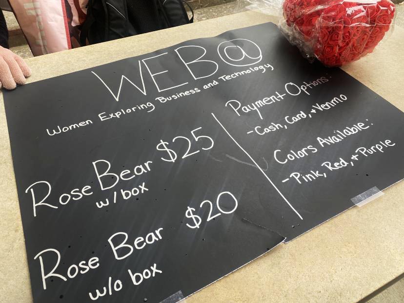 Women Exploring Business and Technology sell rose bears for Valentines Day.