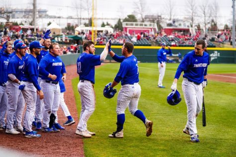 The Eastern Illinois University baseball team comes out of the dugout to celebrate with fellow players after their win against the Arkansas State Razorbacks at Baum-Walker Stadium