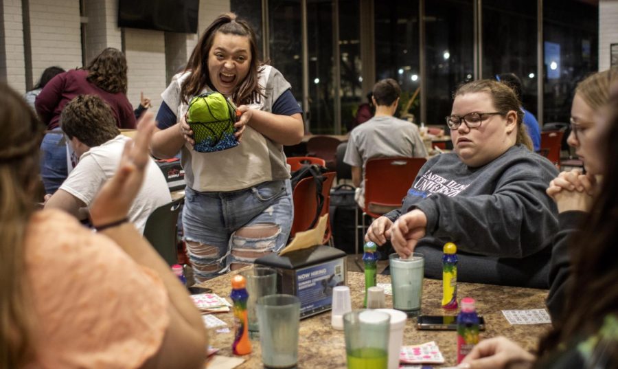 Jaidyn Julius, a freshman special education major, excitedly brings back her prize for bingo-ing during Safety Bingo in Thomas Dining Monday night. Julius said she has gone to every bingo event Eastern has hosted this academic year.