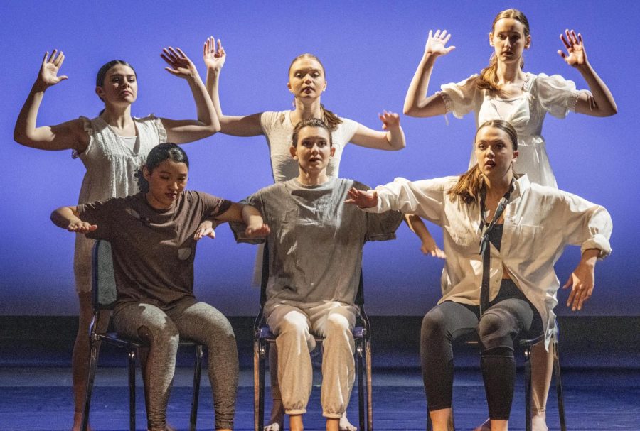 EIU Dancers shift their arms upward in the beginning of the sixteenth song Recovery by James Arthur in the performance In The Spotlight at The Theatre Friday night.