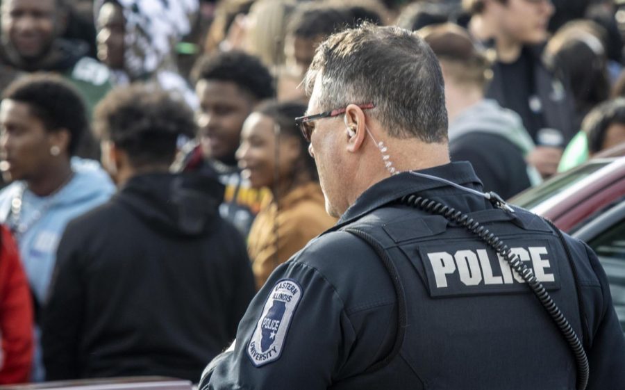 A member of the University Police Department stands and safeguards any potential trouble at an unaffiliated Unofficial house party Saturday afternoon.