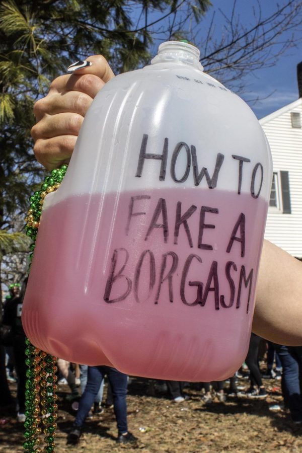 A partygoer shows off their borg at the first Unofficial house party  Saturday morning. A borg stands for blackout rage gallon. People make their own homemade drinks for both safety reasons and person taste. Several partygoers said they prefered to bring their own drinks so they know whats in it. 