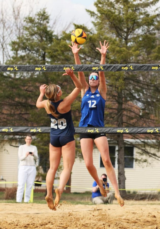 Eastern beach volleyball player, Kate Dean, attempts to block a shot from going over the net as a Missouri Baptist player attempts to put it over the net Monday afternoon in Sister City Park.