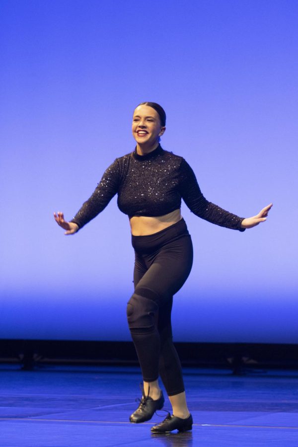 Kate Nemeth, a junior elementary education and Spanish major, performs a tap dance solo to the song Mad World by Tears for Fears during the EIU Dancers In the Spotlight show in the Theatre of Doudna Fine Arts Center Friday night.