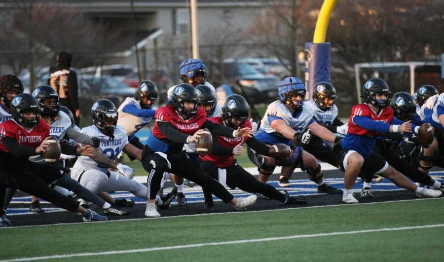 EIUs football team stretches during practice on the OBrien Field Tuesday evening.