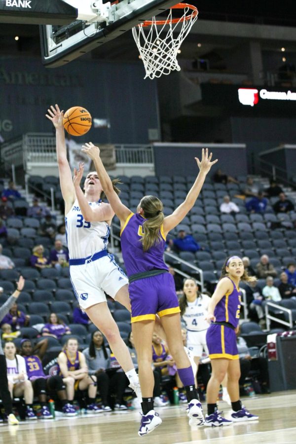 Eastern forward, Macy McGlone (33), attempts to jump up and shoot a layup while a Tennessee Tech player attempts to block her shot at the Ohio Valley Conference Tournament Friday afternoon. The Panthers lost 61-66 to the Golden Eagles.