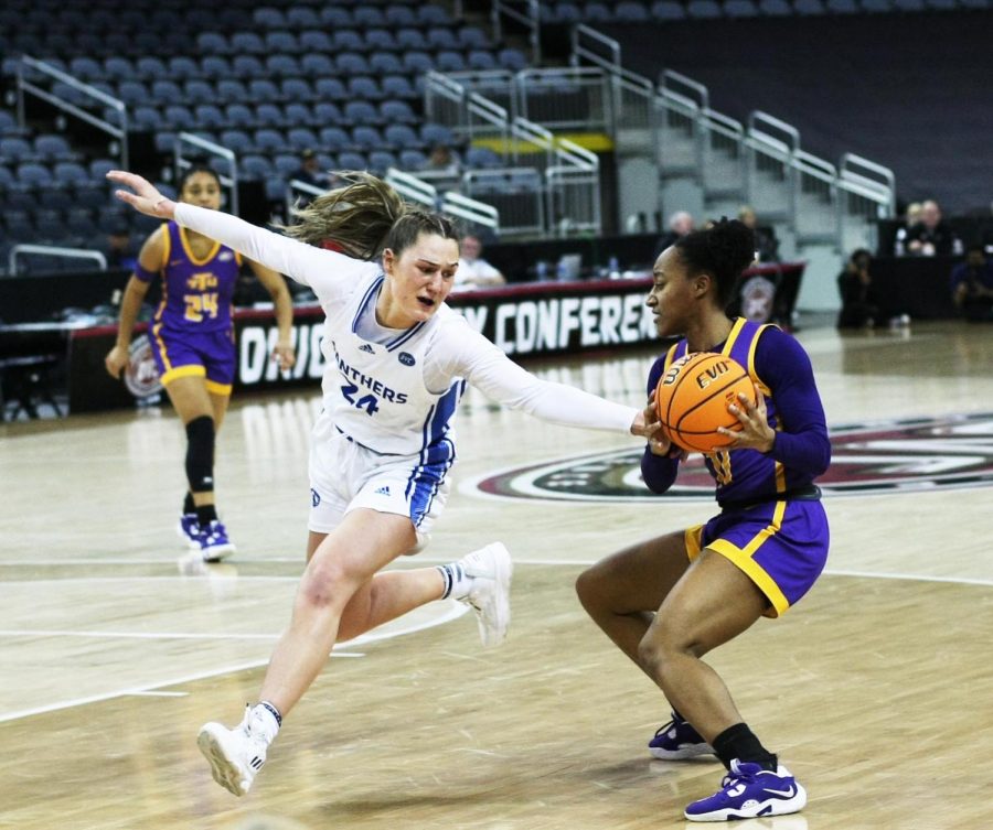 Eastern forward, Morgan Litwiller (24), attempts to take the ball away from a Tennessee Tech player at the Ohio Valley Conference Tournament Friday afternoon. The Panthers lost 61-66 to the Golden Eagles. 