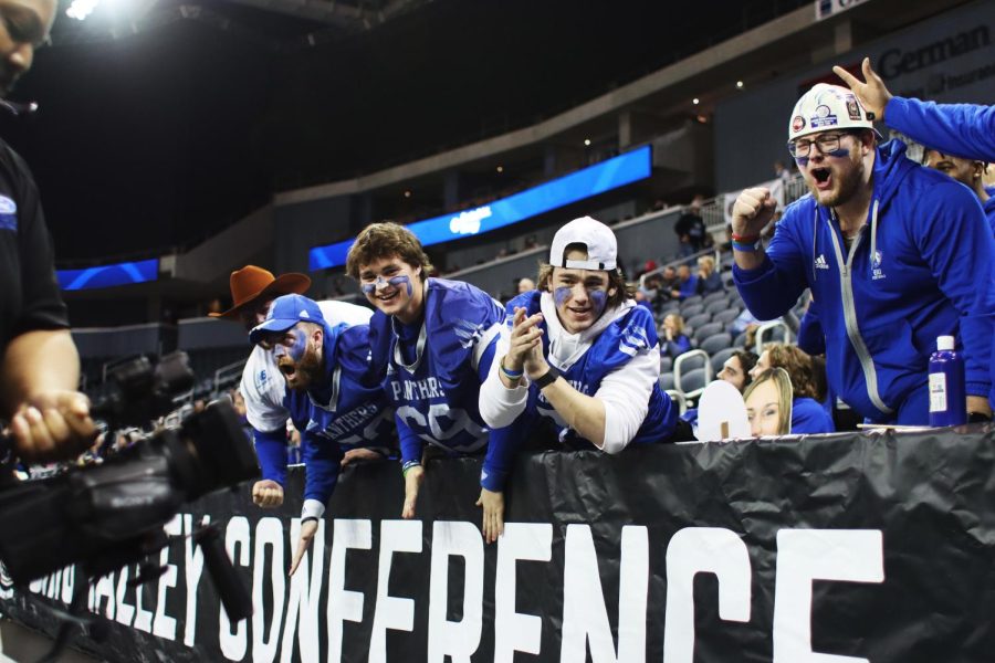 Members of EIUs football team cheer for the camera at the  womens basketball teams game against Tennessee Tech at the Ohio Valley Conference Friday afternoon.