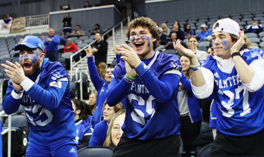 Members of EIUs football team cheer and show support for the womens basketball team during their game against Tennessee Tech at the Ohio Valley Conference Friday afternoon.