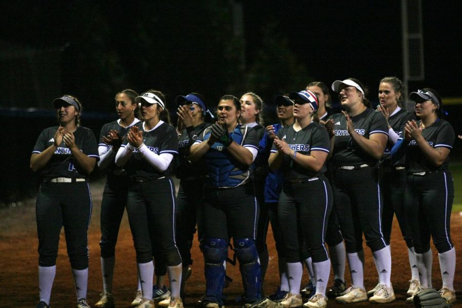 The Eastern softball team sings the EIU Fight Song to the crowd after sweeping SIUE in their home-opener double-header against SIUE on Sunday afternoon on Williams Field.