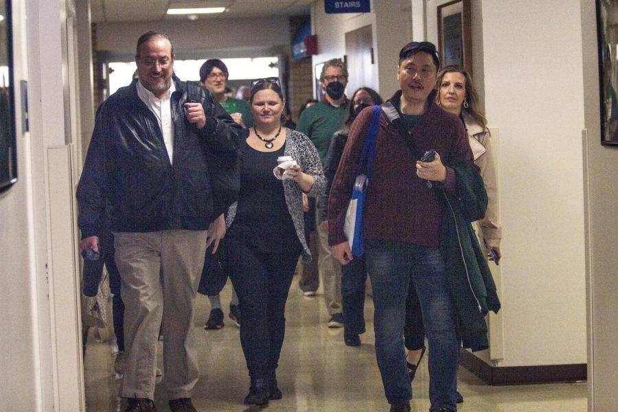 Members of Eastern s chapter of University Professionals of Illinois negotiation team head toward their bargaining meeting at the Union Monday morning.