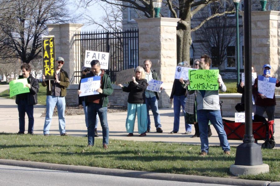 EIU-UPI members gather in front of Old Main for “informational picketing” March 29. They cheered as passing drivers honked in support.
