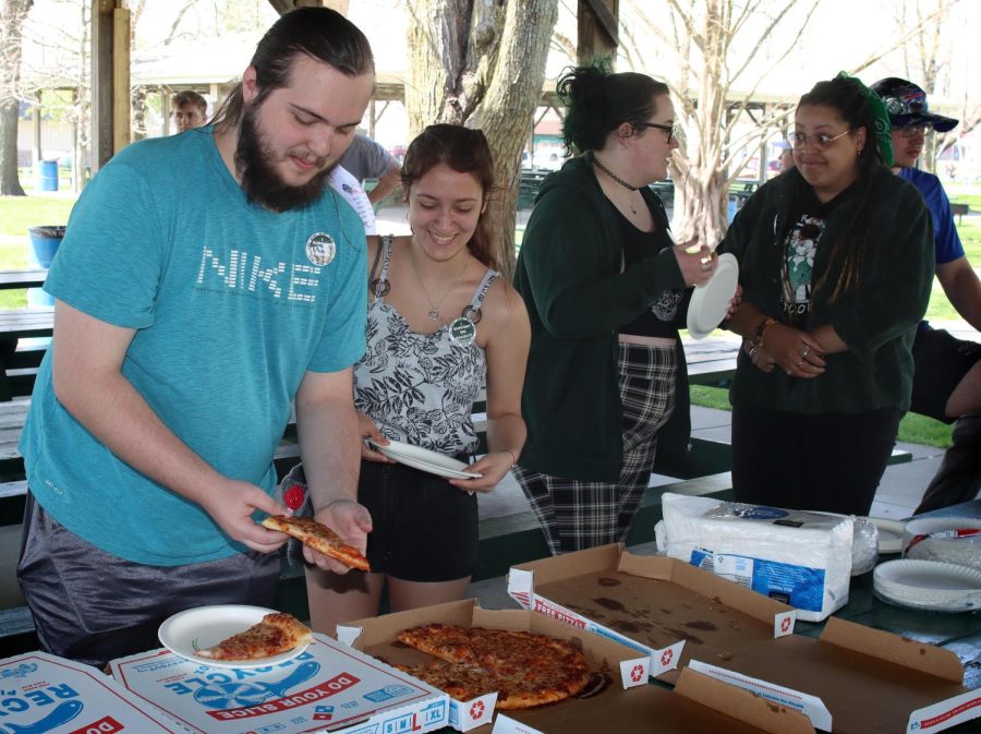 Friends Jthan Ross (left), a sophomore music education major, and Kaity Parker (right), a sophomore music education major, get Dominos pizza at the Student and Community Day morning session at Morton Park Wednesday. Ross said he came to show support during the strike. It feels great to be a part of something that is important, Ross said. 