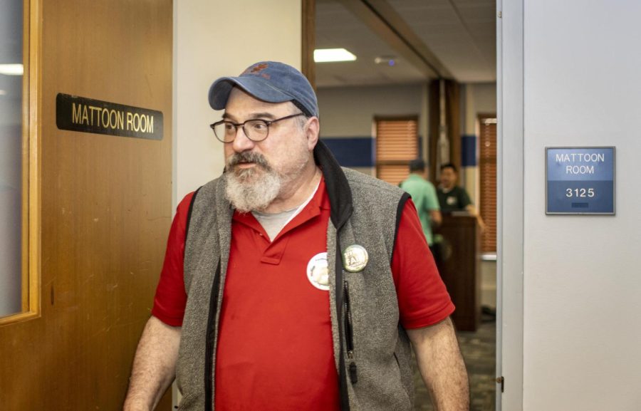 Steve Scher, a psychology professor, walks out of Eastern chapter of University Professionals of Illinois meeting where, after voting, approximately 95 percent voted in favor of striking Tuesday evening. The unions bargaining team made the final decision to strike.