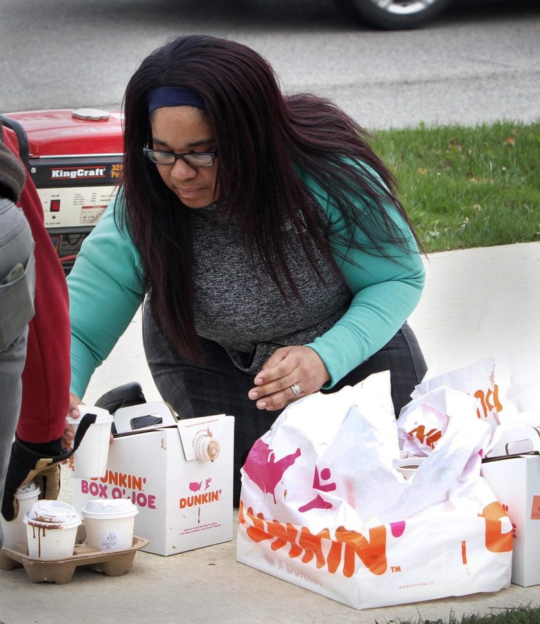 Francesca Jones, an Eastern alumna who studied biosciences, brought Dunkin hot chocolate and doughnuts to union members who were picketing in front of Old Main on Thursday. Jones and her husband, Jermaine, both attended Eastern and had their wedding on campus. They still live in Charleston, and Jones says she wants her children to attend Eastern too because of the support she and her husband received from their professors. I had such a hard time when I started [going to school], I started with two children, Jones said. All my professors, if I said my kids are sick, theyd say, this is what were doing, heres how to make it up. They got us through. 