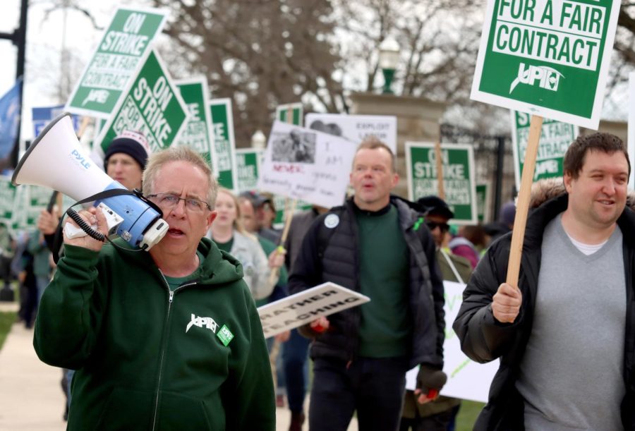 President of the UPI John Miller walks with picketers toward Morton Park from Old Main for a rally on the first day of picketing Thursday morning.