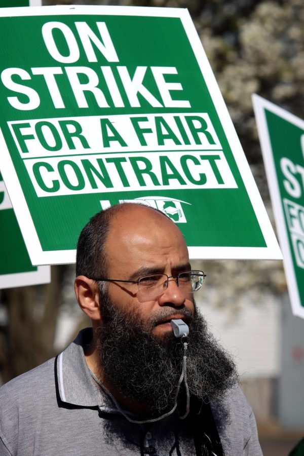 Abidalrahman Abdul Mohd, an assistant professor in the department of hj mathematics and computer science, blows a whistle to the beat of chants during EIU-UPIs third day of picketing for a fair contract Monday morning.