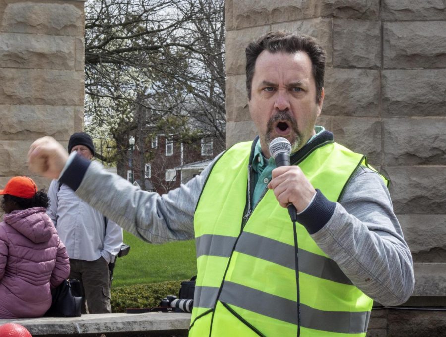 Thomas MacMullen, an instructor in the school of technology, leads chants during picketing Thursday.