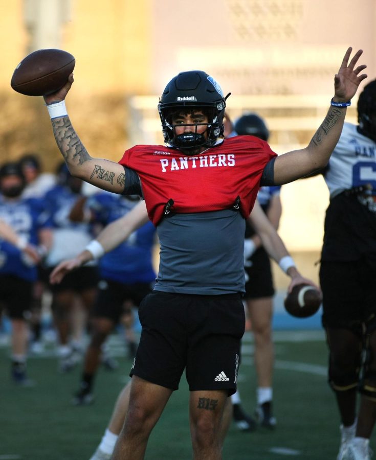 Eastern quarterback, James Cooper Jr. (19), practices stretches with the team during one of their spring practices on the OBrien Field Tuesday evening.