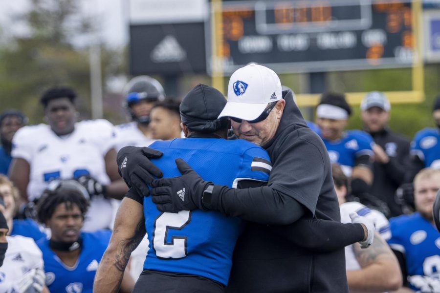 Head football coach Wilkerson hugs defensive back Mark Aitken for being selected as one of the football captains by his teammates on Saturday afternoon on the OBrien Field.