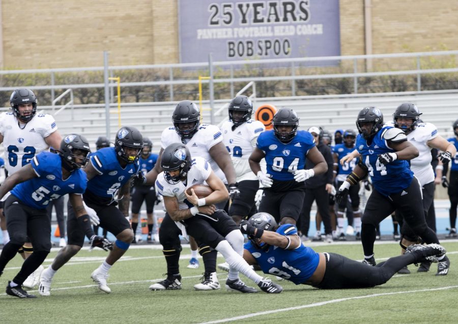 Quarterback James Cooper Jr. gets tackled by defensive lineman Nicholas Oliveira-Chace on a rush attempt Saturday afternoon on the OBrien Field.