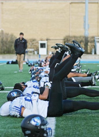 The Eastern football team stretches during practice on OBrien Field Thursday evening.