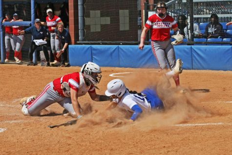Eastern left-fielder, Aryn Henke (12), slides into home plate attempting to score, while Southern Indiana catcher, Sammie Kihega (16), tags her out at home during their game against Southern Indiana on Williams Field Saturday afternoon. The Panthers lost 2-0 to the Screaming Eagles.