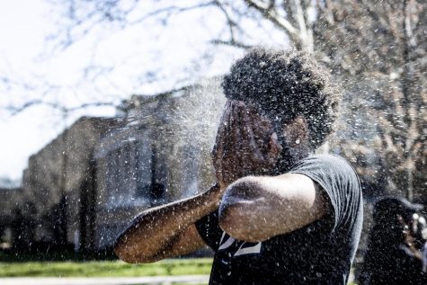 Tavon Evans, a junior TV and video production major, gets sprayed with a water gun at the Mellin Steps Tuesday afternoon for the Splash the NeoZ event presented by Zeta Phi Beta Sorority, Inc. and Phi Beta Sigma Fraternity, Inc. 