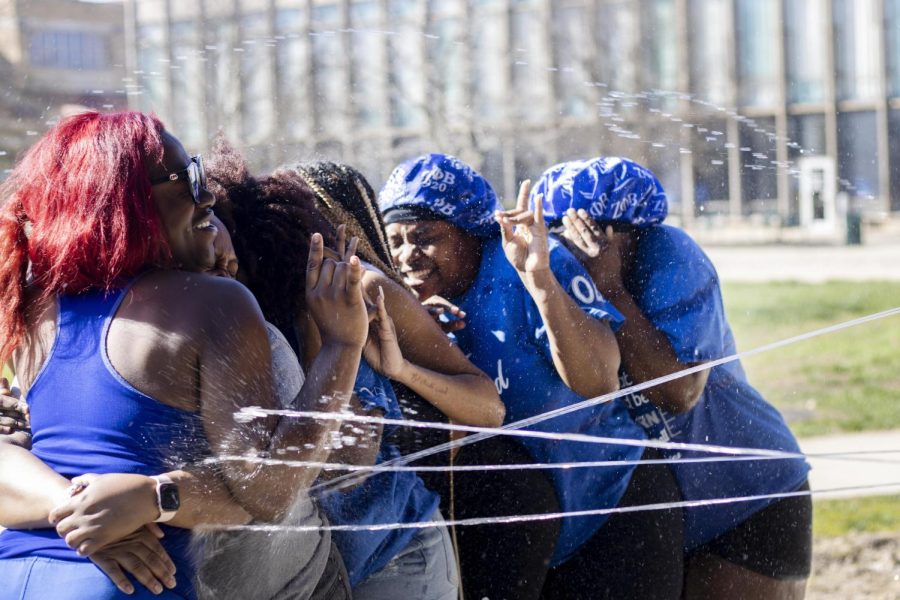 Members of Zeta Phi Beta Sorority, Inc. get hit with water guns for their Splash the NeoZ event with Phi Beta Sigma Fraternity, Inc. Tuesday afternoon.
