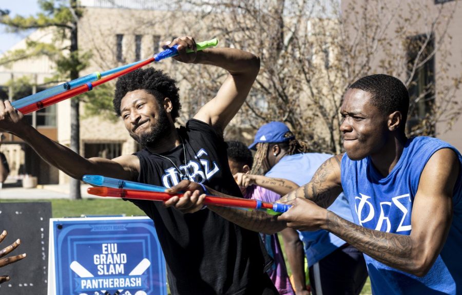 Tavon Evans, a junior TV and video production major and Josiah Moodie, a junior sport management major, spray other people with water guns at the Splash the NeoZ event presented by Zeta Phi Beta Sorority, Inc. and Phi Beta Sigma Fraternity, Inc. on Tuesday afternoon.