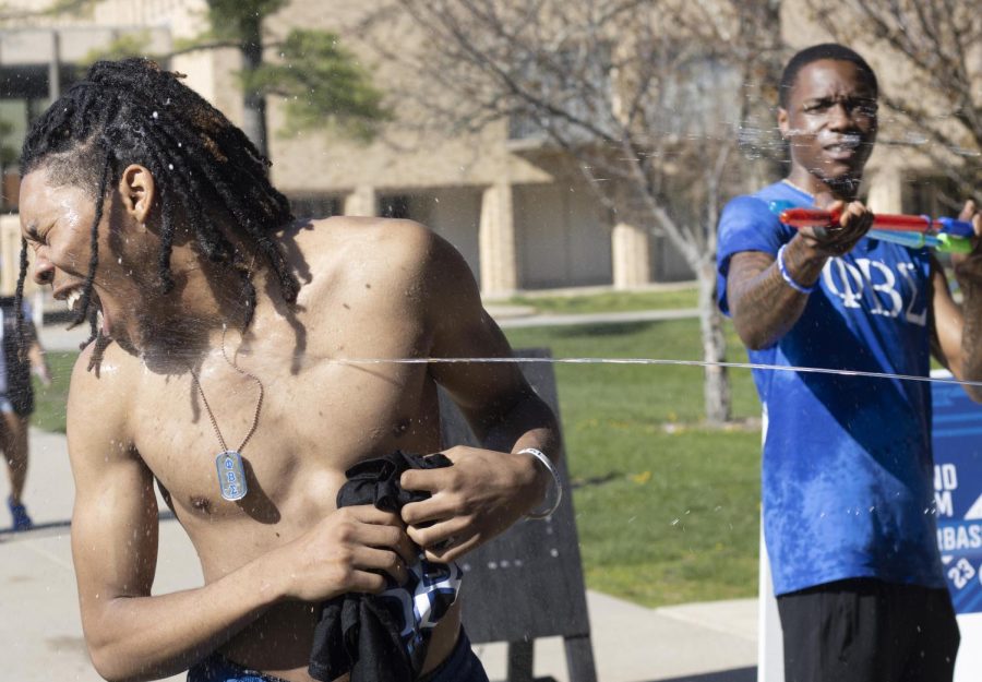 At the Splash the NeoZ event presented by Zeta Phi Beta Sorority, Inc. and Phi Beta Sigma Fraternity, Inc., Marshone Gordon, a sophomore TV and video production major, gets splashed with multiple water guns on Tuesday afternoon.