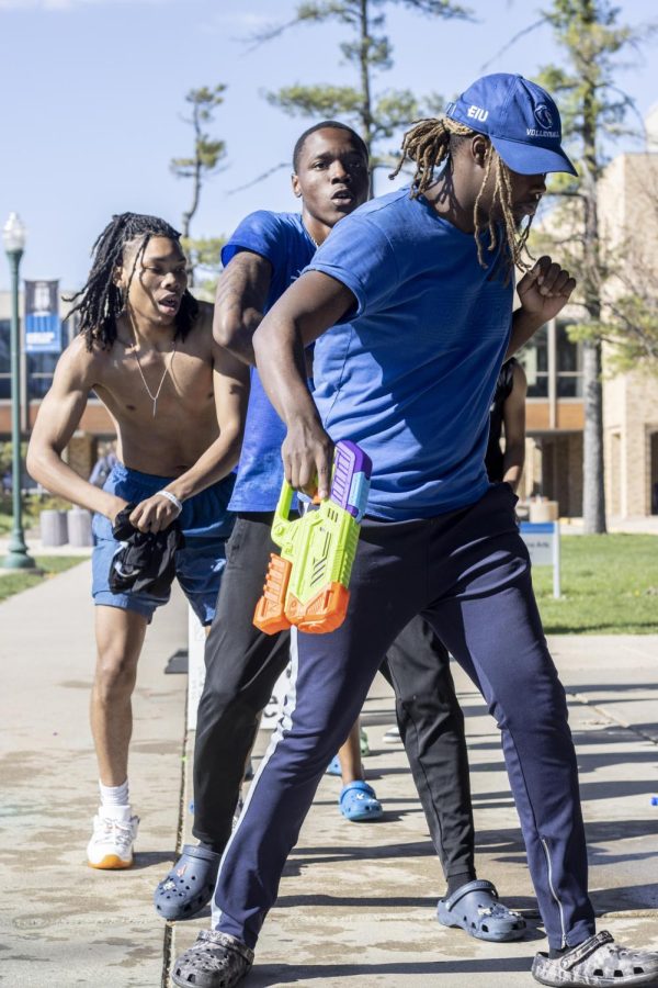 At the Splash the NeoZ event, Zeta Phi Beta Sorority, Inc. and Phi Beta Sigma Fraternity, Inc., take a break from spraying each other and stroll together at the Mellin Steps on Tuesday afternoon.