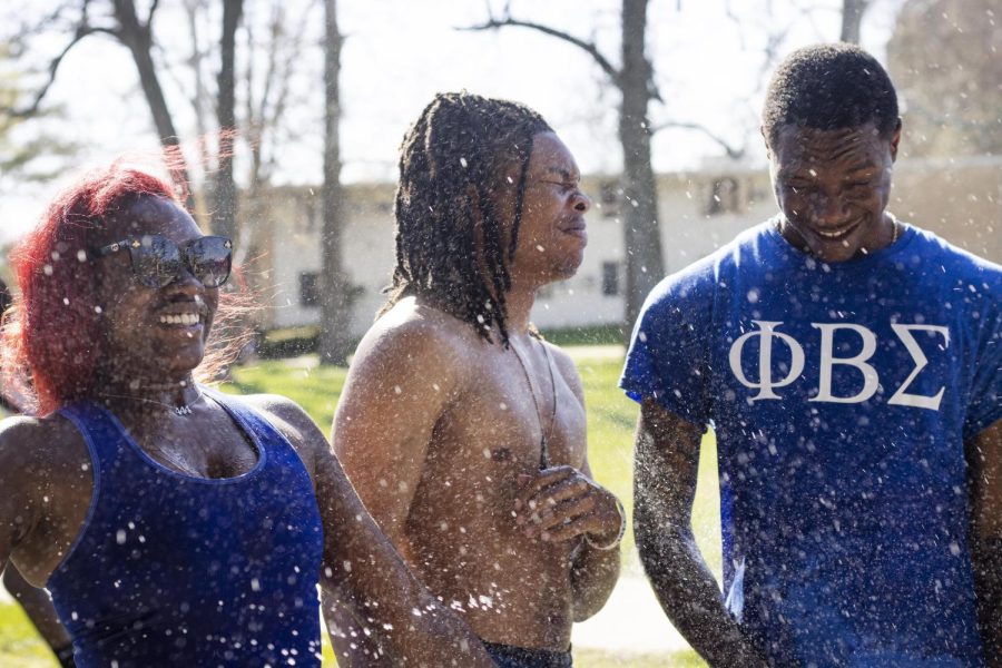 Jaedah Franks, a junior biology pre-med major, Marshone Gordon, a sophomore TV and video production major, and Josiah Moodie, a junior sport management major, all get sprayed with water guns at their Splash the NeoZ event on Tuesday afternoon.