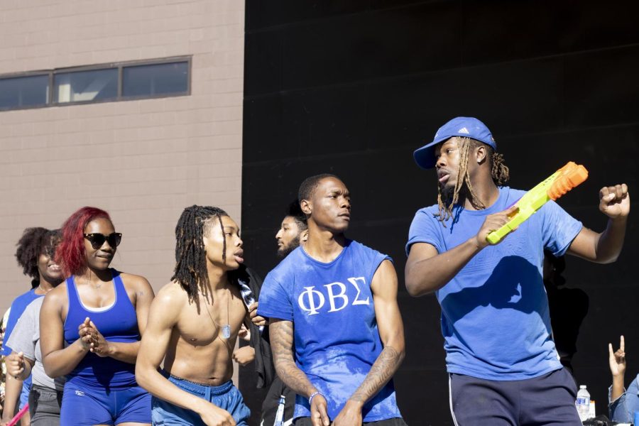 At the Splash the NeoZ event, Zeta Phi Beta Sorority, Inc. and Phi Beta Sigma Fraternity, Inc., take a break from spraying each other and stroll together at the Mellin Steps Tuesday afternoon.