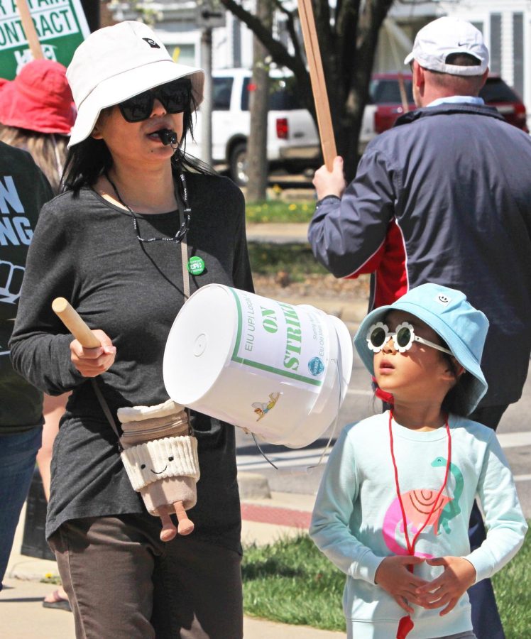 A EIU-UPI member and daugther walk the picket line together in front of Old Main on strike day three on Monday.
