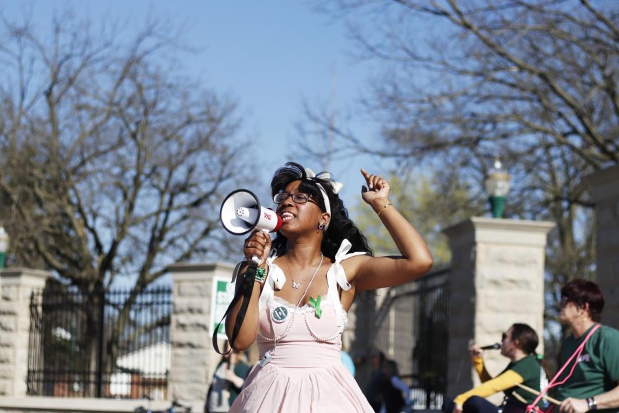 Tatiana Stringer, a sophomore health adminstration major, supports the faculty striking for a fair contract by joining them at the picket lines and yelling into the speaker phone Wednesday afternoon in front of Old Main.