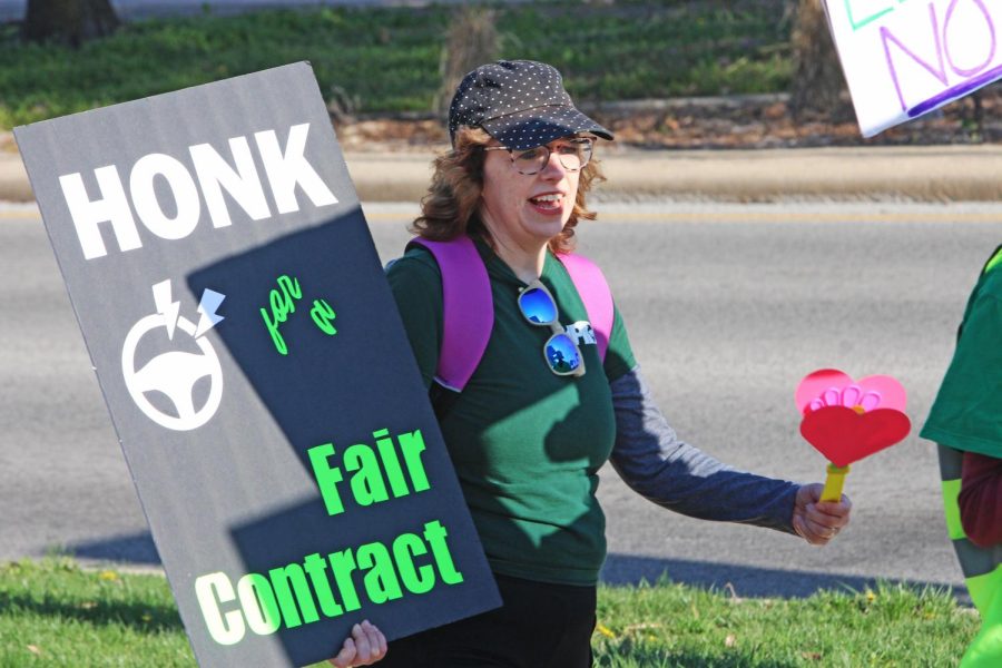 Kristin Routt, a professor of Spanish, walked the EIU-UPI strike picket line with a sign she made, which says Honk for a Fair Contract on Monday.