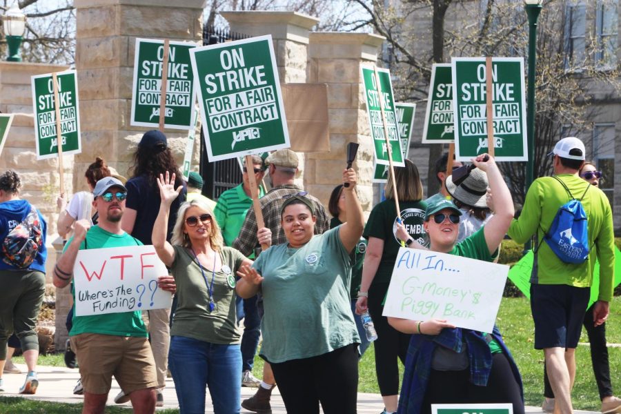 University Professionals of Illinois, EIU-UPI, members stand beside Lincoln Ave. as they encouraged drivers to honk their car horns in support of the union on Monday.