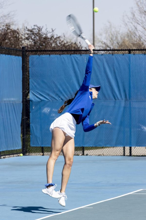 Senior Brittany Steven jumps high to be able to strike the ball back across the court during her singles match against the Southern Illinois University Edwardsville Cougars on the Rex Darling Courts Saturday afternoon. The Panthers lose 5-2.