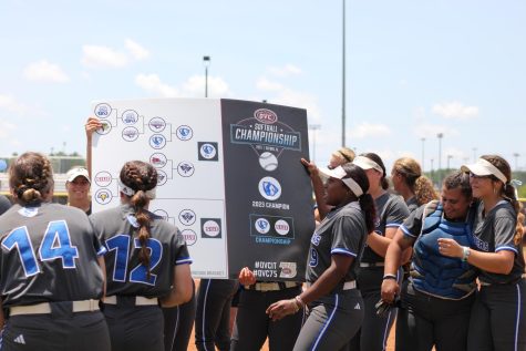 Eastern’s softball team holds up the championship bracket in celebration after winning the OVC Softball championship against SIUE 2-0 Saturday in Oxford, Ala.